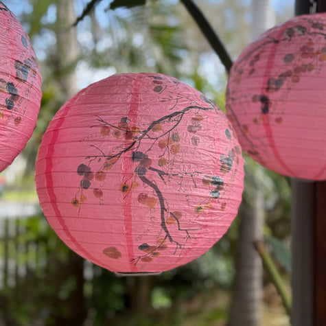 Pink printed lanterns hanging from trees