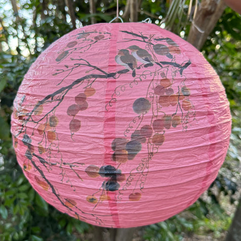 Pink paper lantern with birds and trees