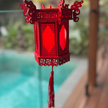 Red Chinese lantern hanging under pool deck