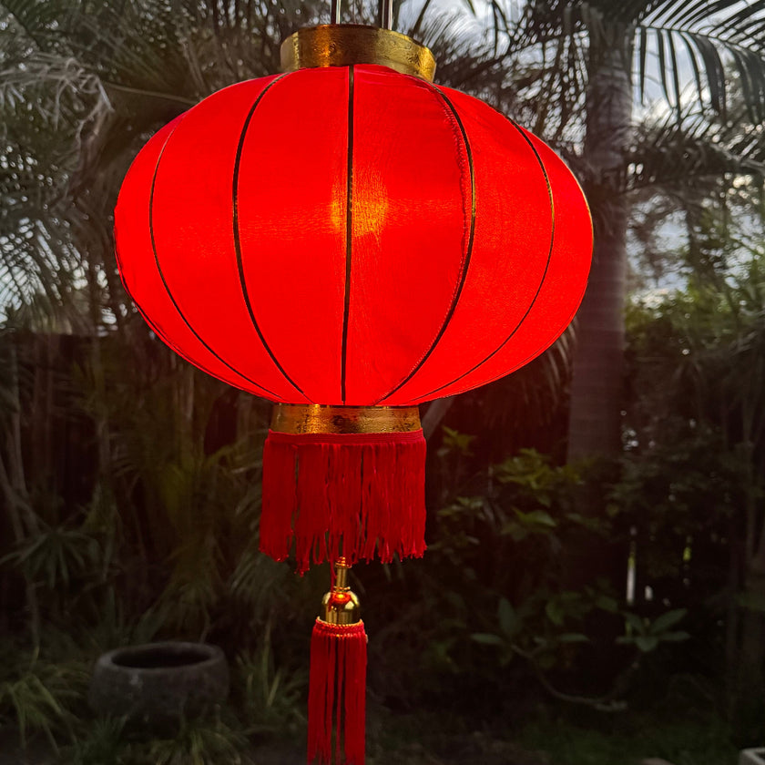 Chinese new year lantern red and gold hanging in tropical garden