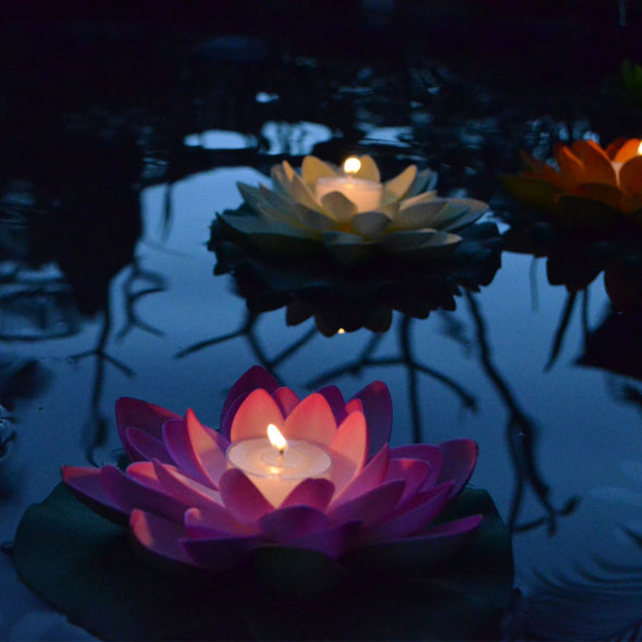 illuminated floating lotus flower with candle