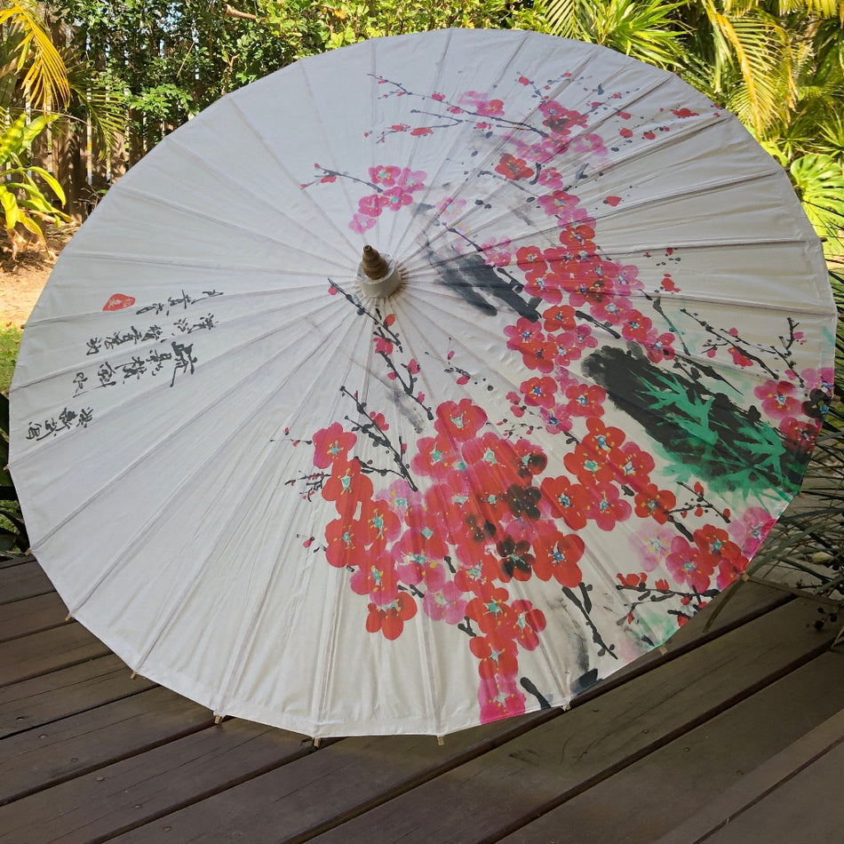 cherry blossom paper parasol with Chinese characters on timber deck