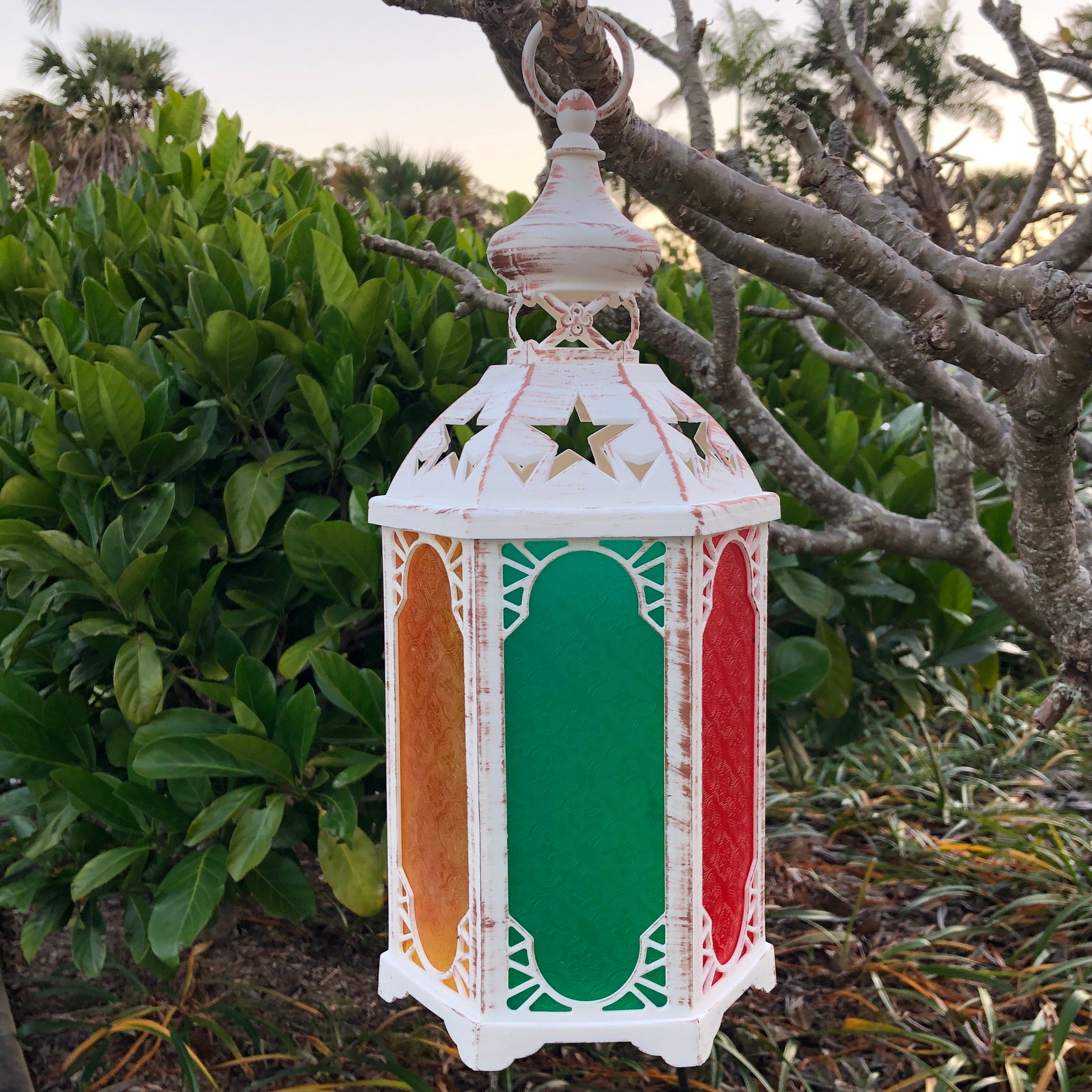 battery operated Moroccan lantern hanging in tree