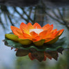 orange floating lotus flower with candle
