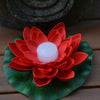 red floating lotus flower with candle
